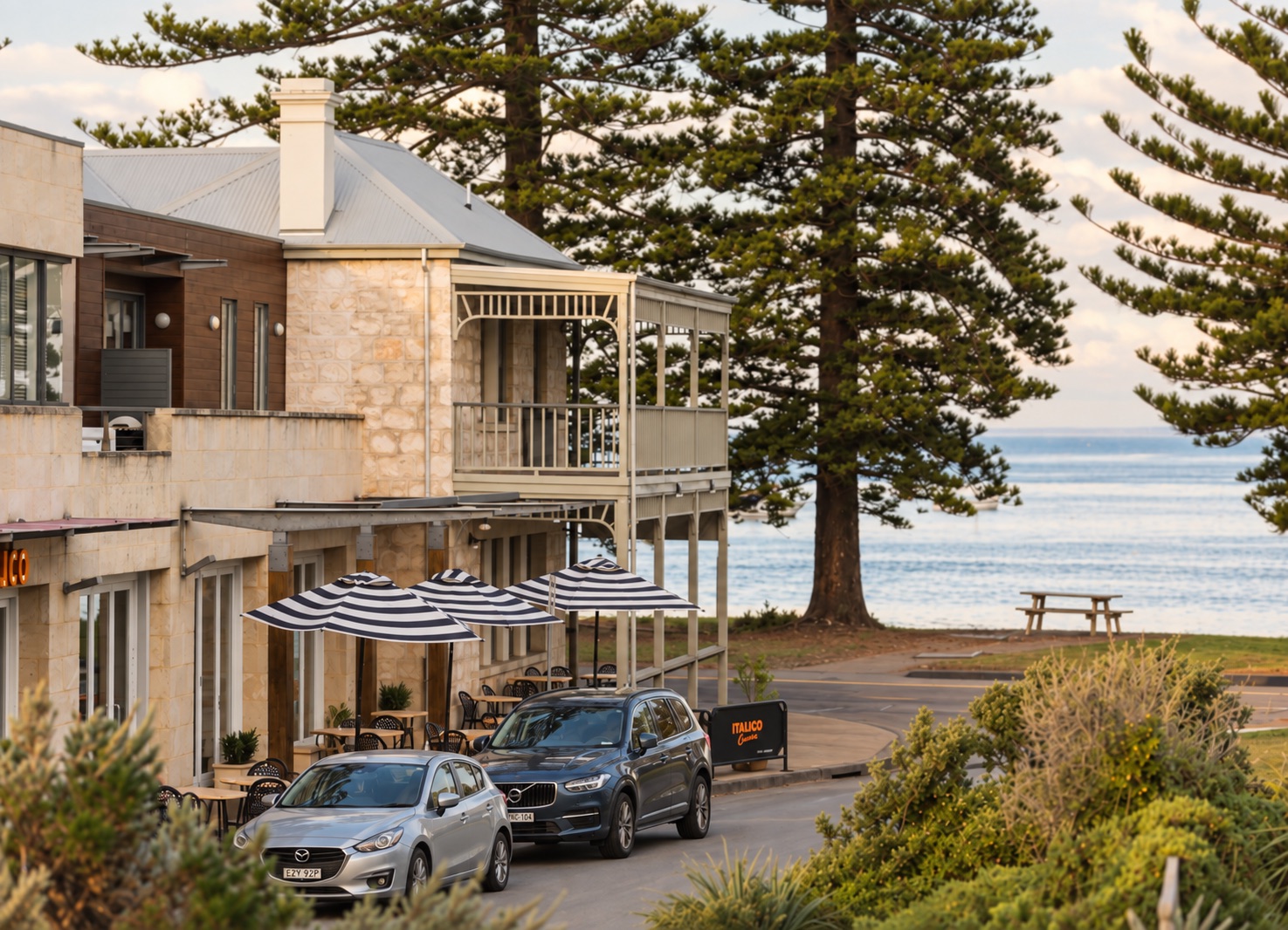 Sorrento coastal streetscape with seaside buildings, pine trees and ocean views
